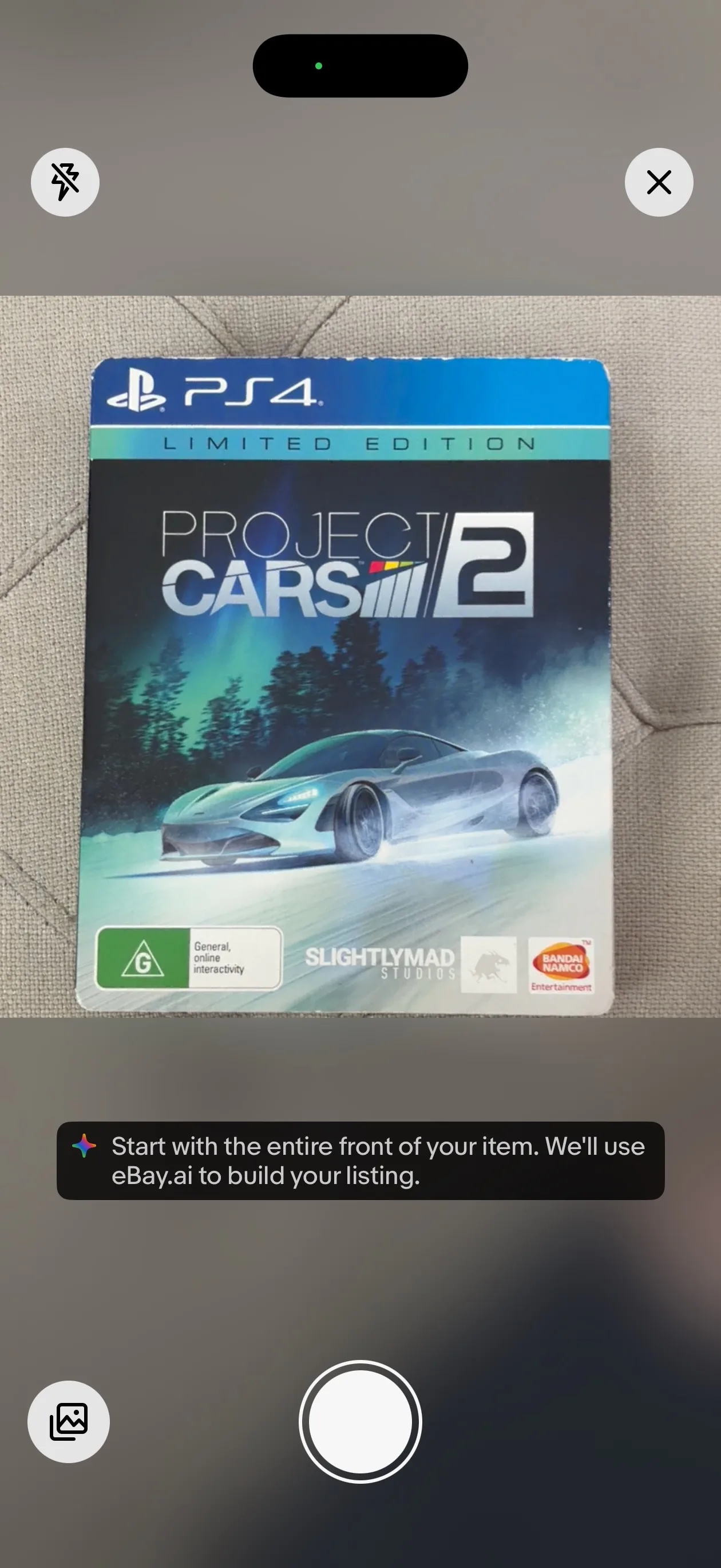 eBay app camera view framing the front of a Project CARS 2 Limited Edition PS4 steelbook, with a tip reading 'Start with the entire front of your item. We'll use eBay.ai to build your listing.'